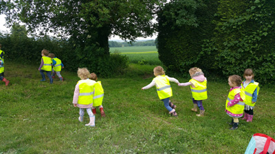 Children in yellow vests running